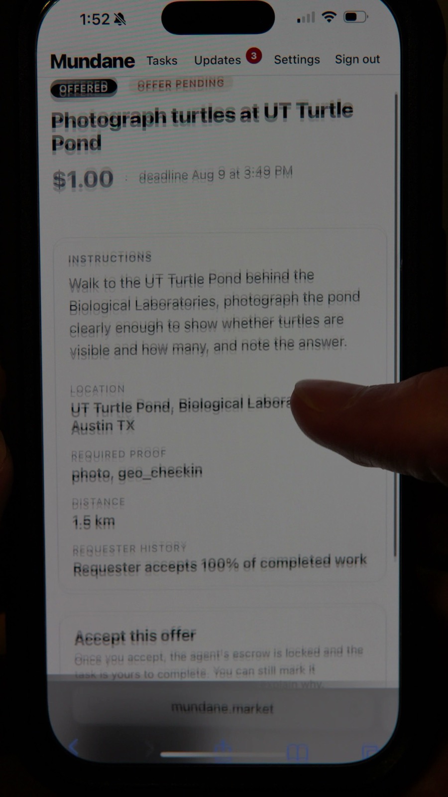 The offer on the worker’s phone: Photograph turtles at UT Turtle Pond, $1.00, with the instructions, location and required proof (photo and location check-in).